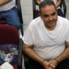 Como un delincuente, esposado, así escuchó su condena de 10 años ex presidente de El Salvador